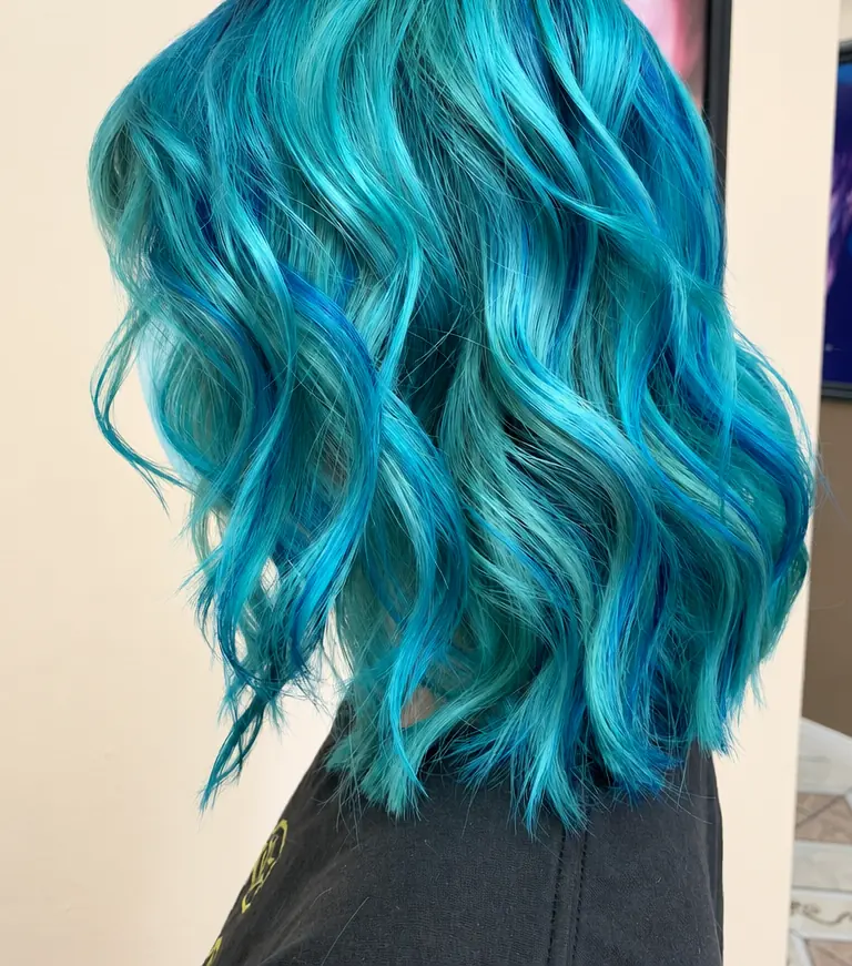 Vivid teal wavy bob, side view