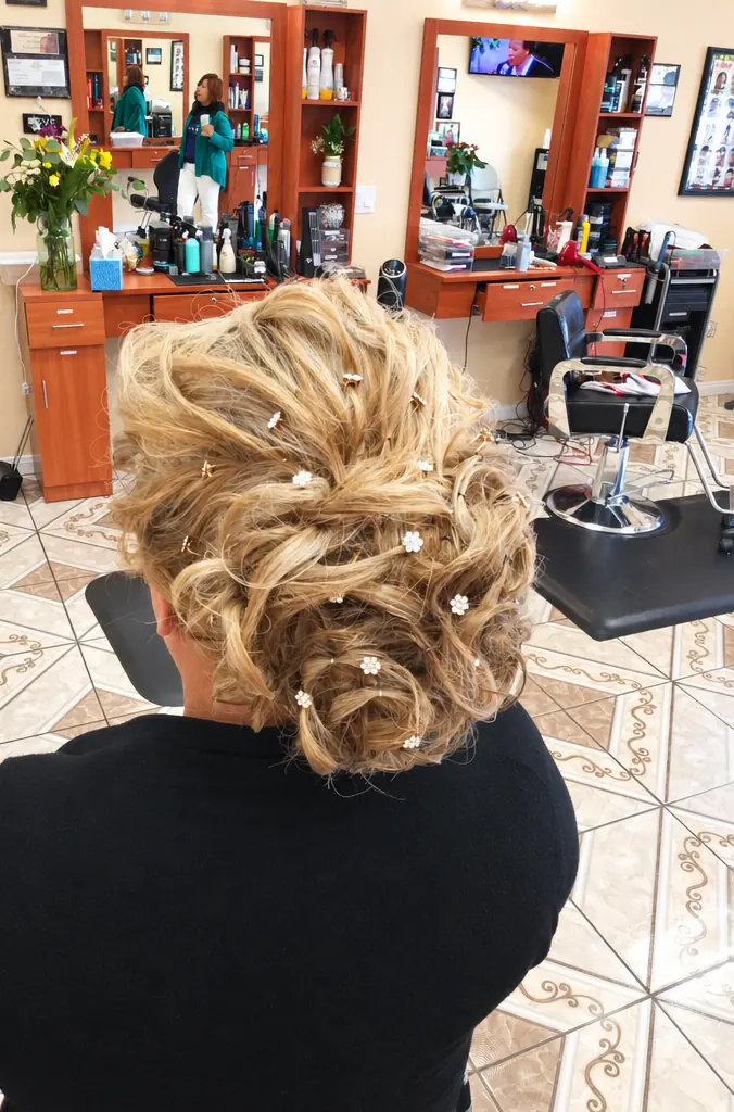 Soft updo with pearl pins in the salon, back view